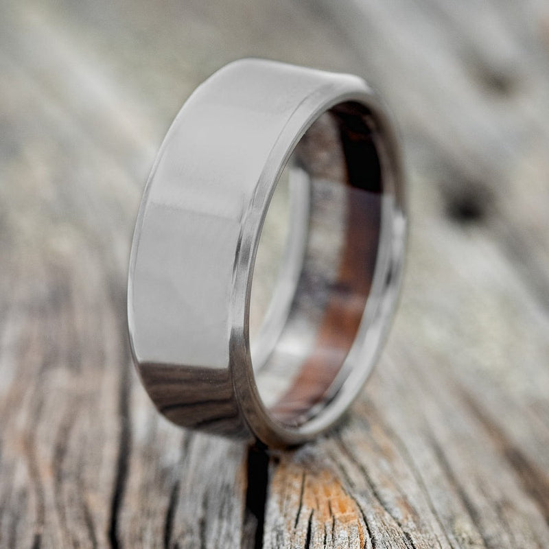 Shown here is a custom, handcrafted men's wedding ring featuring an elk antler and ironwood lining, upright facing left. Additional inlay options are available upon request.