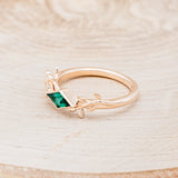Shown here is "Sparrow", a lab-created emerald women's engagement ring with a sparrow embellishment, facing left. Many other center stone options are available upon request.