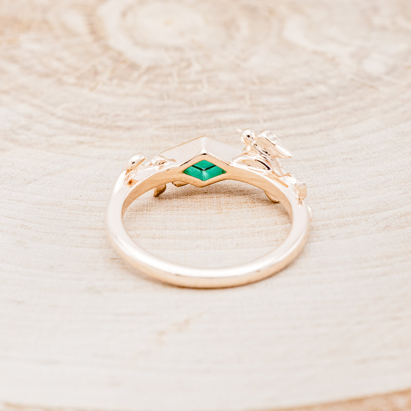 Shown here is "Sparrow", a lab-created emerald women's engagement ring with a sparrow embellishment, back view. Many other center stone options are available upon request.