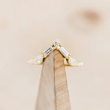 Shown here is "Melody", a 14K gold v-shaped tracer with 1/4 CTW diamonds, on stand front facing.