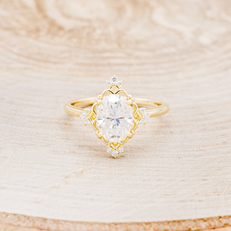 Shown here is "Treva", an oval moissanite women's engagement ring set with diamond accents, front facing. Many other center stone options are available upon request.