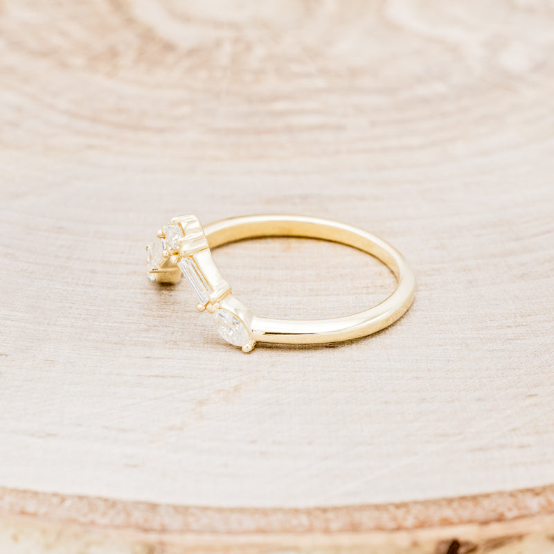 Shown here is "Melody", a 14K gold v-shaped tracer with 1/4 CTW diamonds, facing left.
