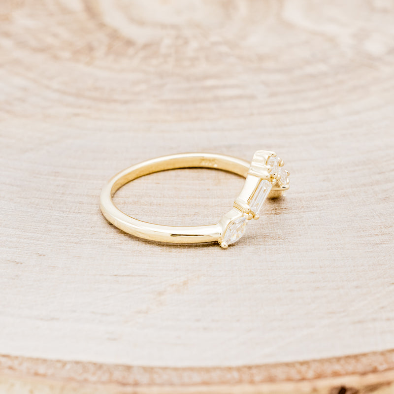 Shown here is "Melody", a 14K gold v-shaped tracer with 1/4 CTW diamonds, facing right.