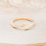 Shown here is "Serpent", a snake-style wedding band featuring diamond accents, front facing.