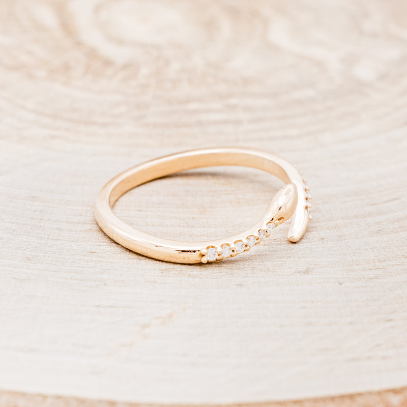 Shown here is "Serpent", a snake-style wedding band featuring diamond accents, facing right.