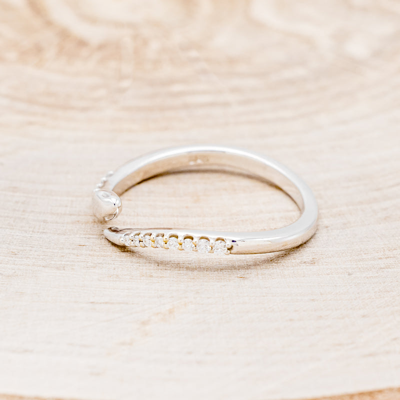 Shown here is "Serpent", a snake-style wedding band featuring diamond accents, facing left.
