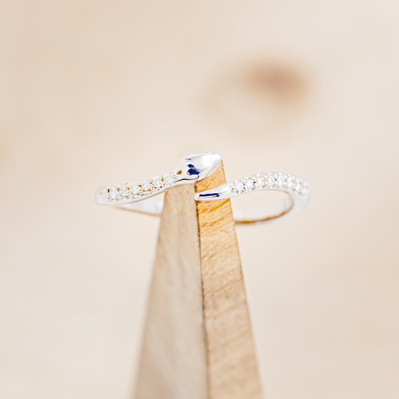 Shown here is "Serpent", a snake-style wedding band featuring diamond accents, on stand front facing.