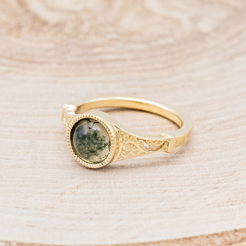 Shown here is "Selene", an accented-style moss agate women's engagement ring, facing left. Many other center stone options are available upon request.
