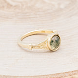 Shown here is "Selene", an accented-style moss agate women's engagement ring, facing right. Many other center stone options are available upon request.