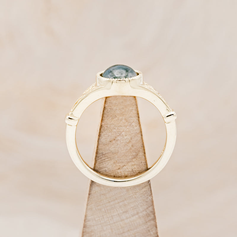 Shown here is "Selene", an accented-style moss agate women's engagement ring, side view on stand. Many other center stone options are available upon request.