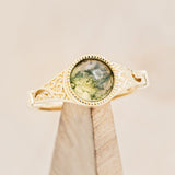 Shown here is "Selene", an accented-style moss agate women's engagement ring, on stand front facing. Many other center stone options are available upon request.  