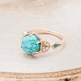 Shown here is "Lucy in the Sky", a halo-style hexagon turquoise women's engagement ring with diamond accents and turquoise inlays, facing left. Many other center stone options are available upon request.