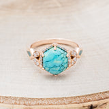 Shown here is "Lucy in the Sky", a halo-style hexagon turquoise women's engagement ring with diamond accents and turquoise inlays, front facing. Many other center stone options are available upon request.