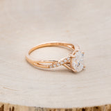 Shown here is "Roslyn", an oval moissanite women's engagement ring with diamond accents, facing right. Many other center stone options are available upon request.