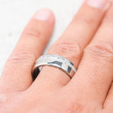 Shown here, Vertigo, a handcrafted men's wedding ring featuring an elk antler inlay, on hand.