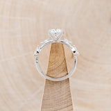 "FLORA" - ROUND CUT MOISSANITE ENGAGEMENT RING WITH LEAF-SHAPED DIAMOND ACCENTS