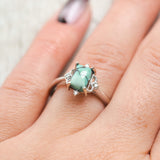 Shown here, Zella, a turquoise women's engagement ring with diamond accents, on hand. Many other center stone options are available upon request. 