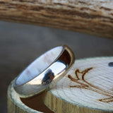 Shown here isA custom, handcrafted men's wedding ring featuring an antler lining with a 14K gold band and a domed profile. Additional inlay options are available upon request.-14K GOLD WEDDING BAND WITH ANTLER LINING AND DOMED PROFILE (available in 14K yellow, white, or rose gold) - Staghead Designs - Antler Rings By Staghead Designs