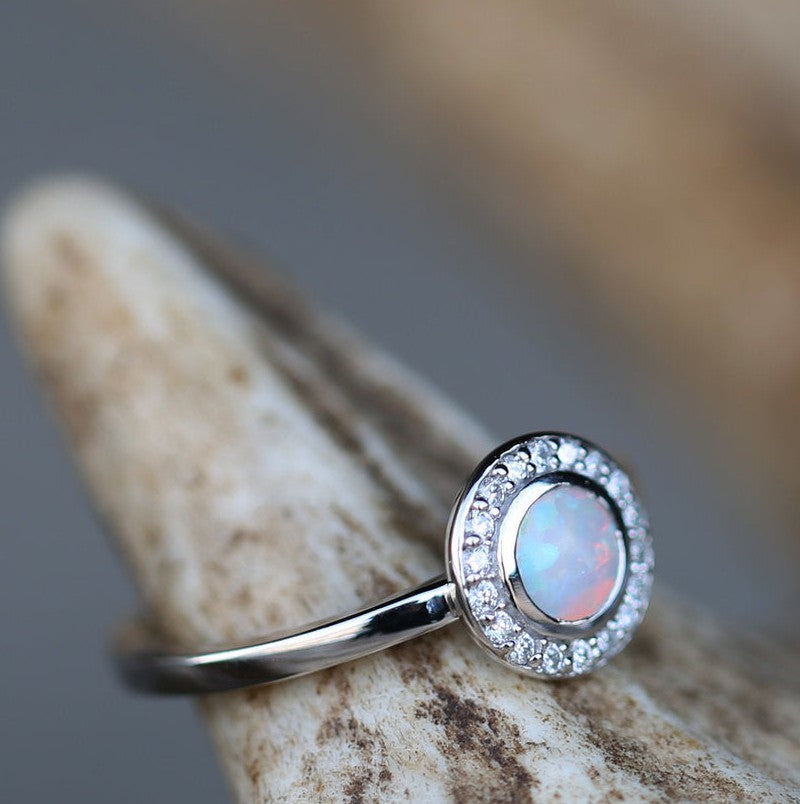  Shown here is The "Terra", a halo-style round opal women's engagement ring with delicate and ornate details and is available with many center stone options- "TERRA" IN 14K GOLD WITH OPAL AND DIAMOND HALO (available in 14K rose, white & yellow gold) - Staghead Designs - Antler Rings By Staghead Designs