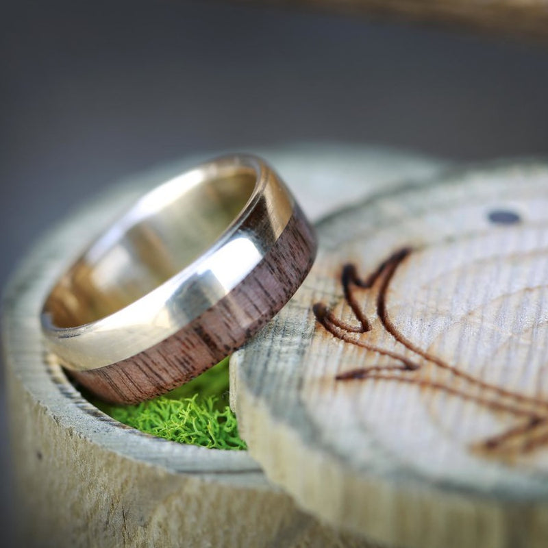 pictured is  a 14k gold "Ledger" with black walnut overlay ! "Ledger" is a custom, handcrafted men's wedding ring featuring a 14k gold band with black walnut wood. Additional inlay options are available upon request.